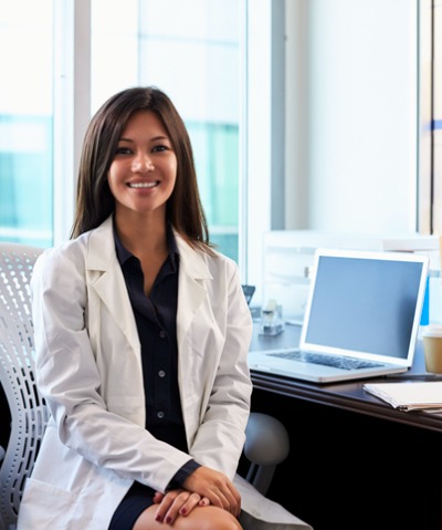 Female dermatologist sitting near her computerp Female dermatologist sitting near her computerp